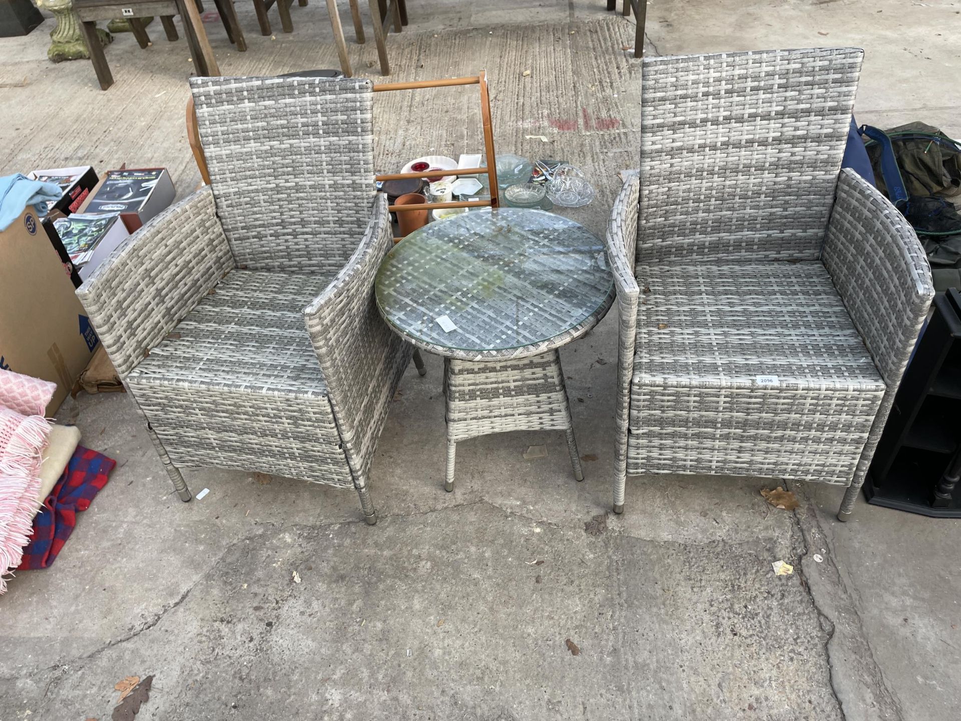 A RATTAN PATIO SET COMPRISING OF TWO CHAIRS AND A ROUND SIDE TABLE