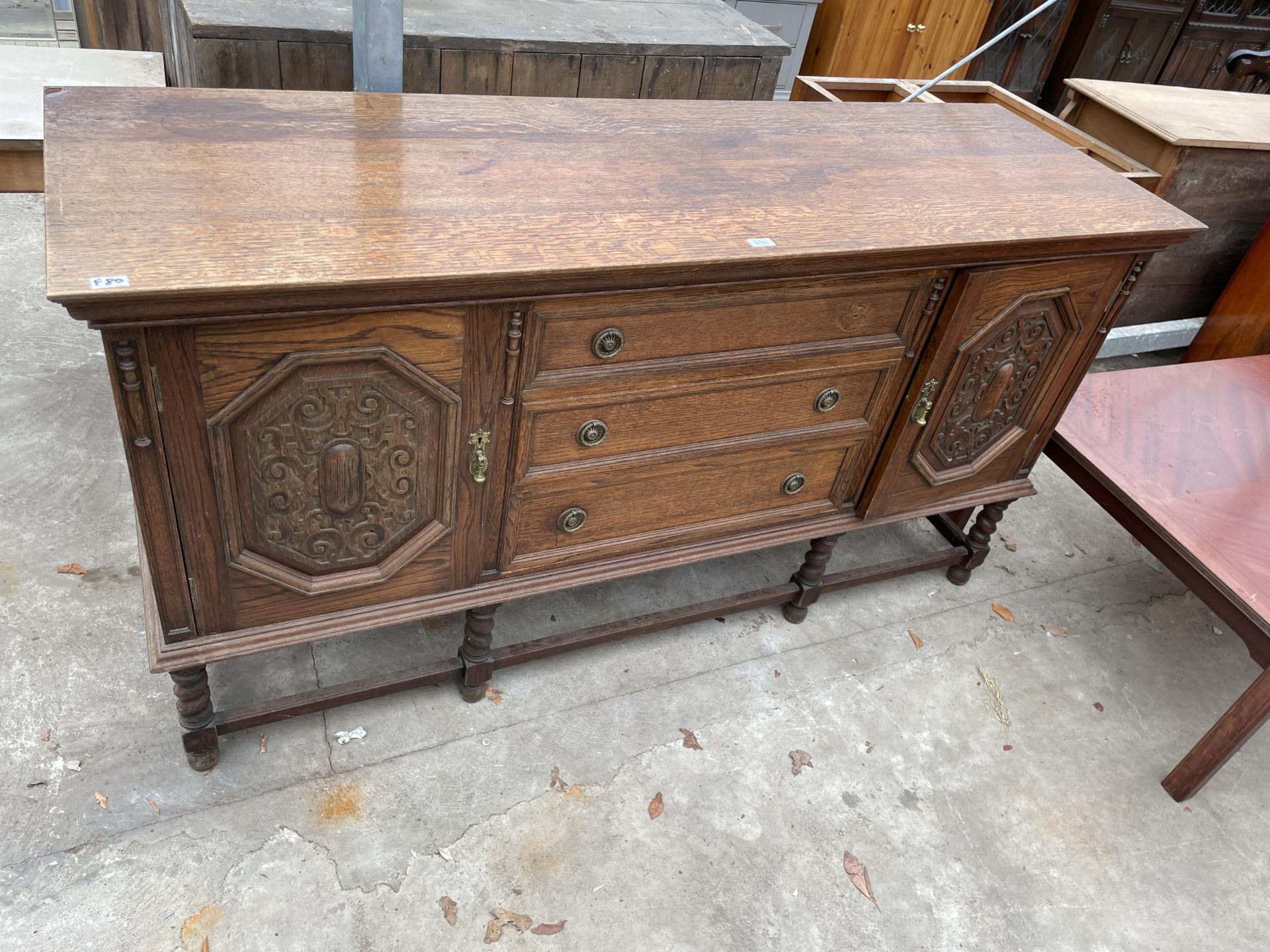 AN EARLY 20TH CENTURY OAK JACOBEAN SIDEBOARD ON BARLEY TWIST LEGS, 72" WIDE