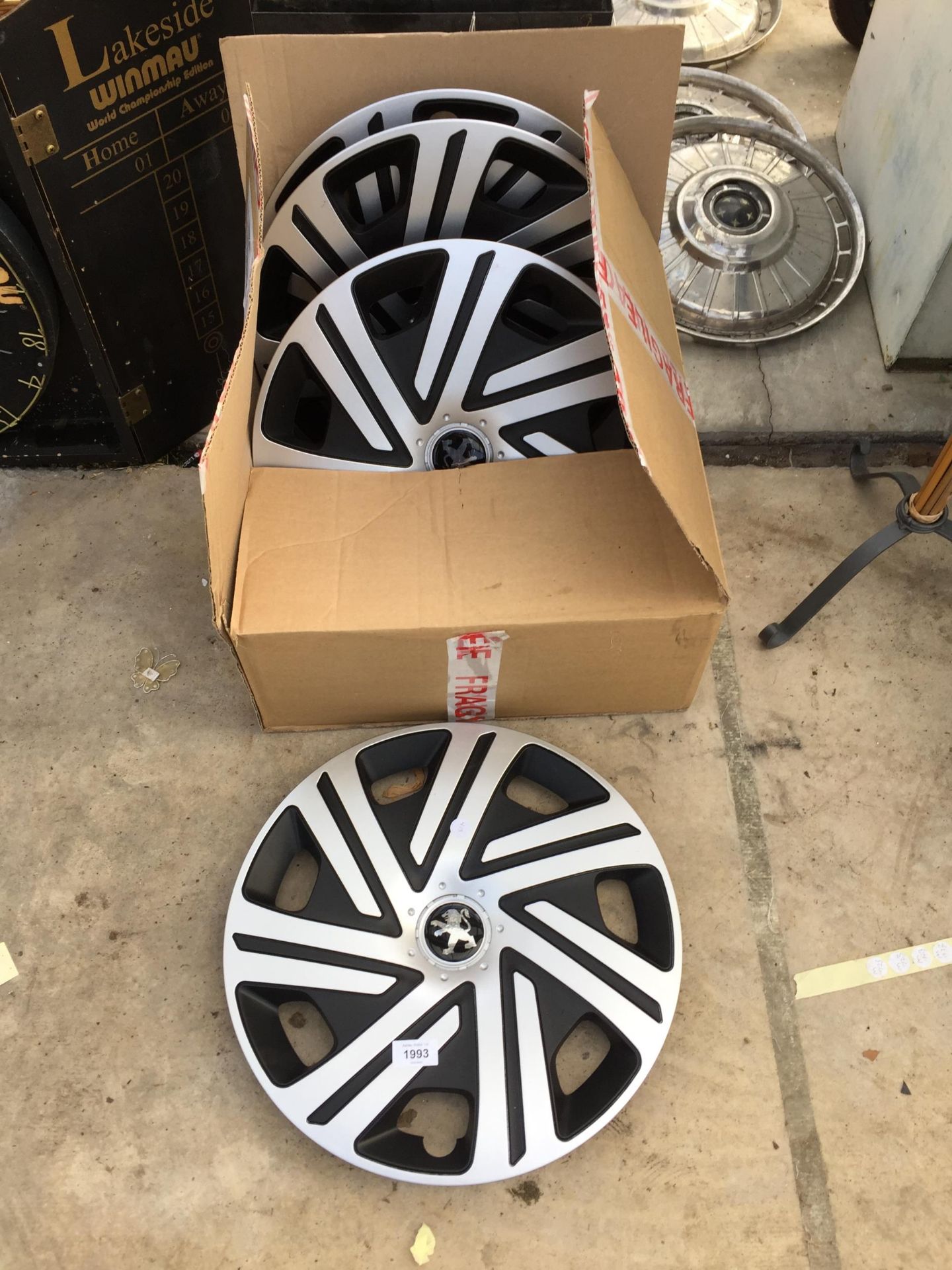 A SET OF FOUR PEUGEOT WHEEL COVERS