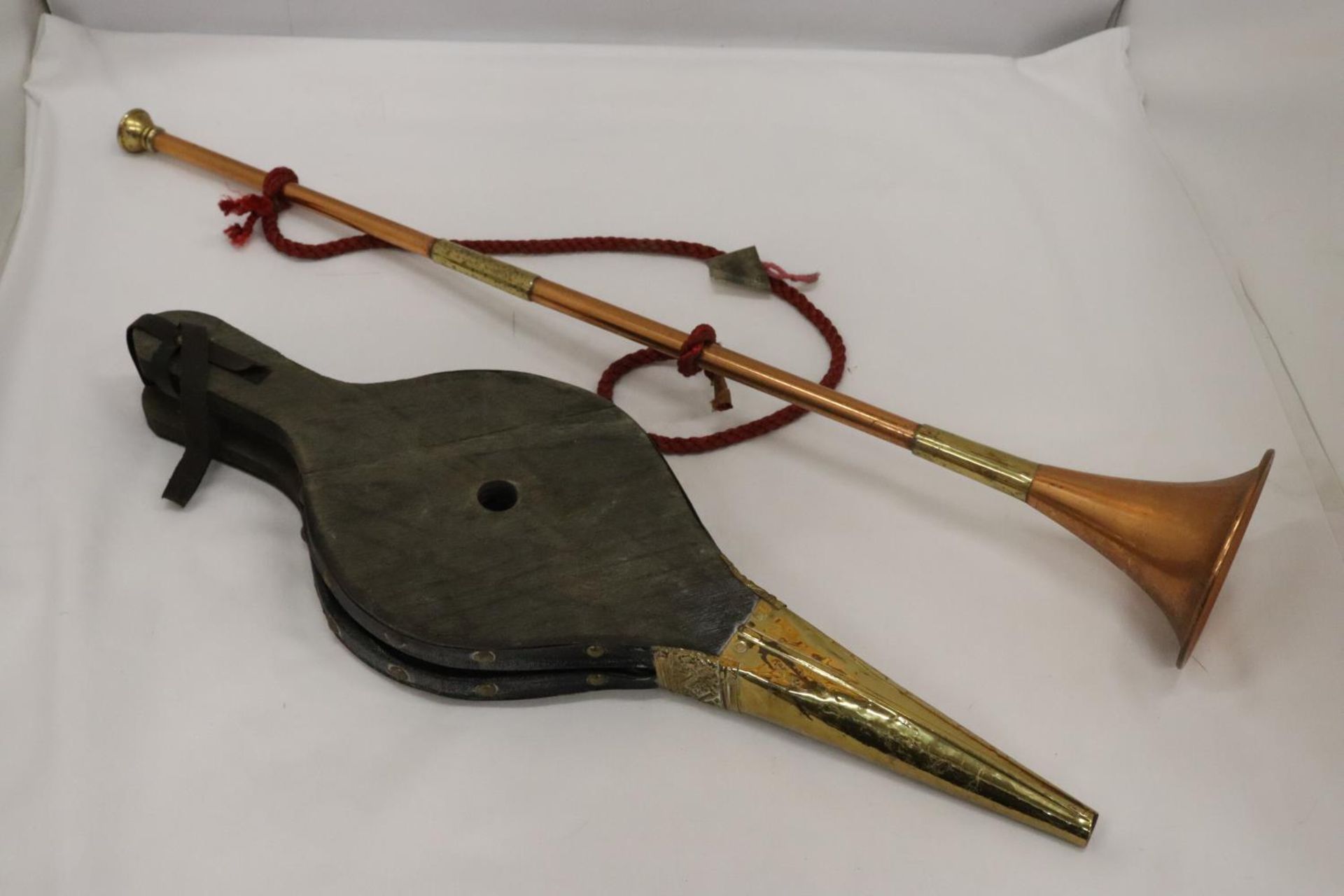 A COPPER AND BRASS HUNTING HORN AND A PAIR OF BRASS BELLOWS