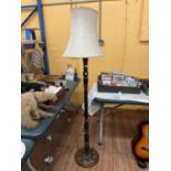 A MAHOGANY BARLEY TWIST STANDARD LAMP AND SHADE