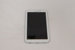 A SAMSUNG TABLET WITH CHARGER, VENDOR STATES IN WORKING ORDER, NO WARRANTY GIVEN, 11CM X 19CM