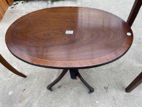 AN OVAL MAHOGANY CROSSBANDED PEDESTAL OCCASIONAL TABLE