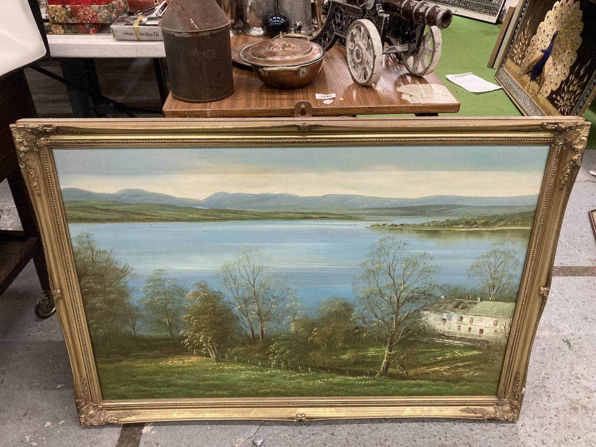 A LARGE GILT FRAMED SIGNED OIL ON CANVAS OF A LAKE SCENE 100CM X 69CM