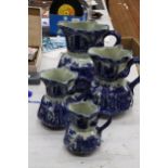 FOUR MATCHING, GRADUATING BLUE AND WHITE IRONSTONE JUGS, LARGEST HEIGHT 23CM