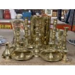 A QUANTITY OF BRASSWARE TO INCLUDE CANDLESTICKS, SHELL CASES, MIRROR, PHOTOGRAPH FRAME ETC
