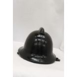 A BLACK VINTAGE FIREMAN'S HELMET