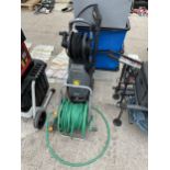 A HOSE REEL AND A KARCHER XPERT HD PRESSURE WASHER