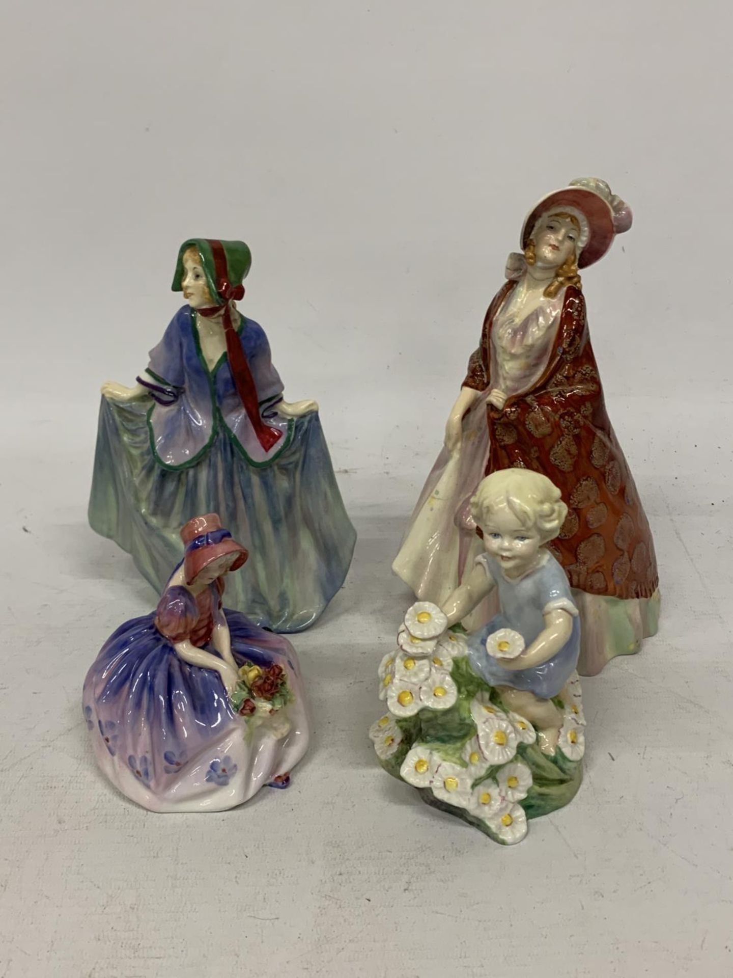 FOUR FIGURES TO INCLUDE THREE ROYAL DOULTON SWEET ANNE (A/F), MAY, THE PAISLEY SHAWL (A/F) AND A