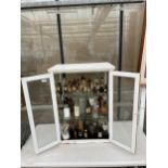 A VINTAGE APOTHECARY CABINET CONTAINING A LARGE ASSORTMENT OF VINTAGE GLASS MADICINE BOTTLES