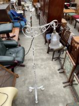 A CAST AND WROUGHT IRON STANDARD LAMP ON TRIPOD BASE WITH PRETTY SMOKED GLASS SHADE