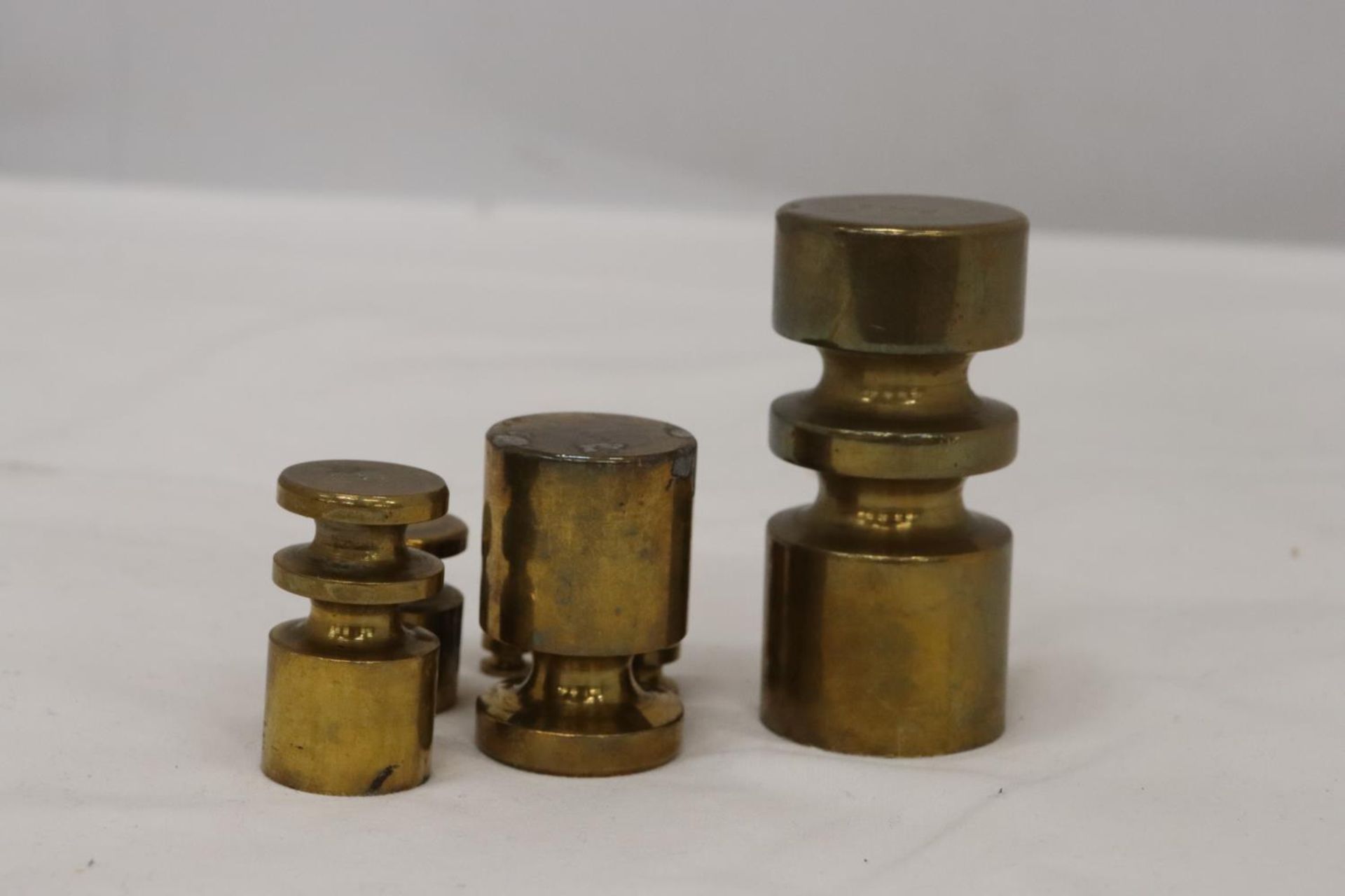 A SET OF BRASS WEIGHTS