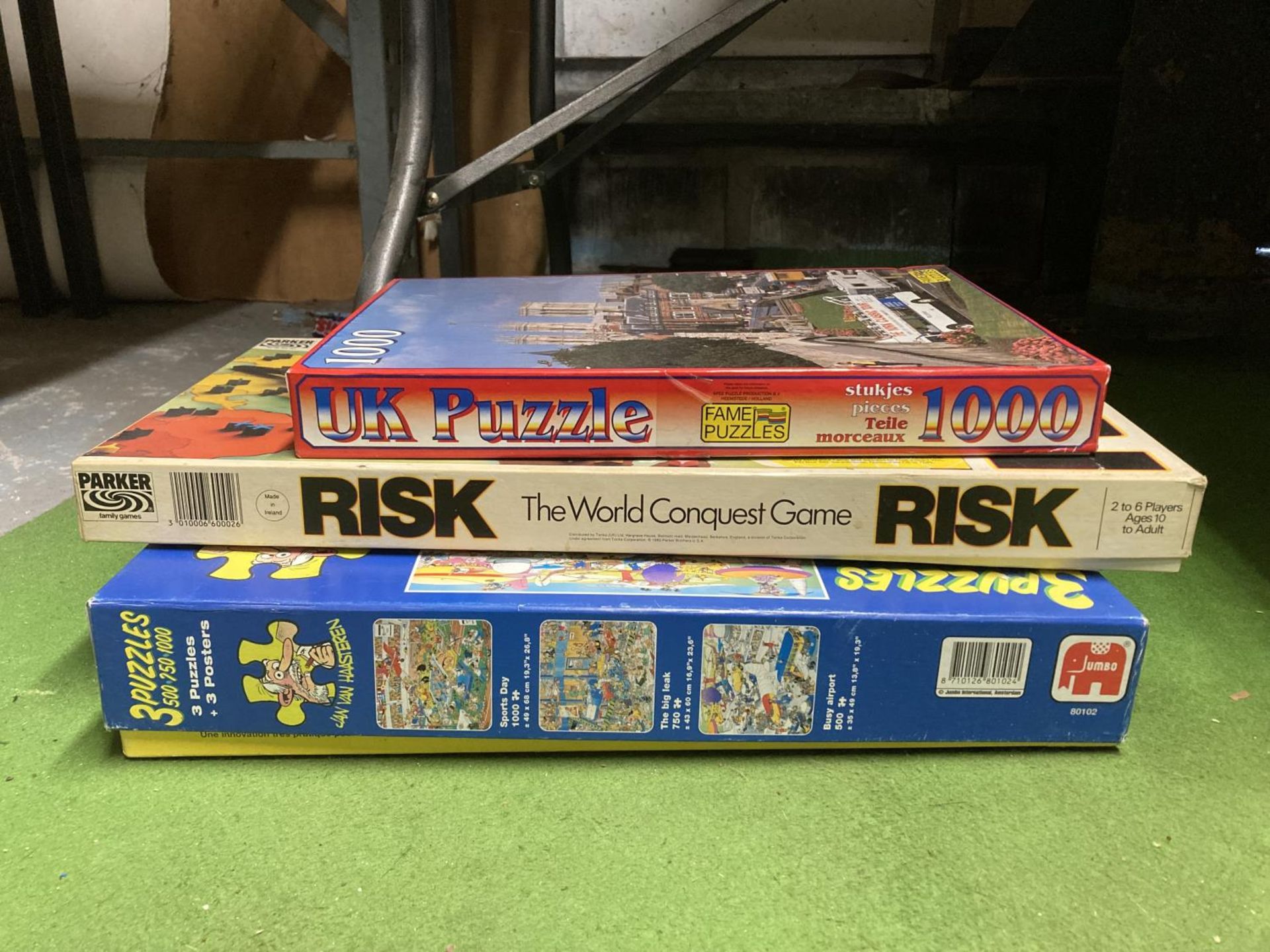 A RISK BOARD GAME AND TWO JIGSAW PUZZLES