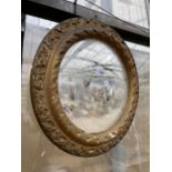 A GILT FRAMED CIRCULAR WALL MIRROR