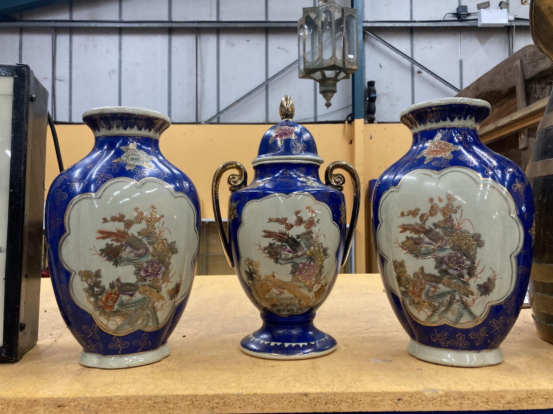 THREE LARGE DECORATIVE ORIENTAL PIECES TO INCLUDE TWO VASE AND A TWIN HANDLED LIDDED URN