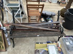 A WOODEN SLATTED GARDEN BENCH WITH CAST ENDS FOR RESTORATION