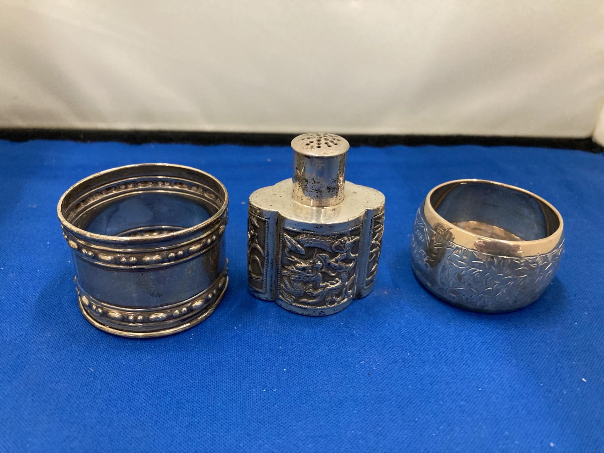 THREE SILVER ITEMS TO INCLUDE TWO HALLMARKED BIRMINGHAM NAPKIN RINGS GROSS WEIGHT 59.67 GRAMS