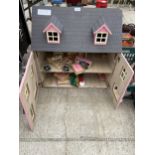 A LARGE WOODEN DOLLS HOUSE WITH AN ASSORTMENT OF DOLLS FURNITURE