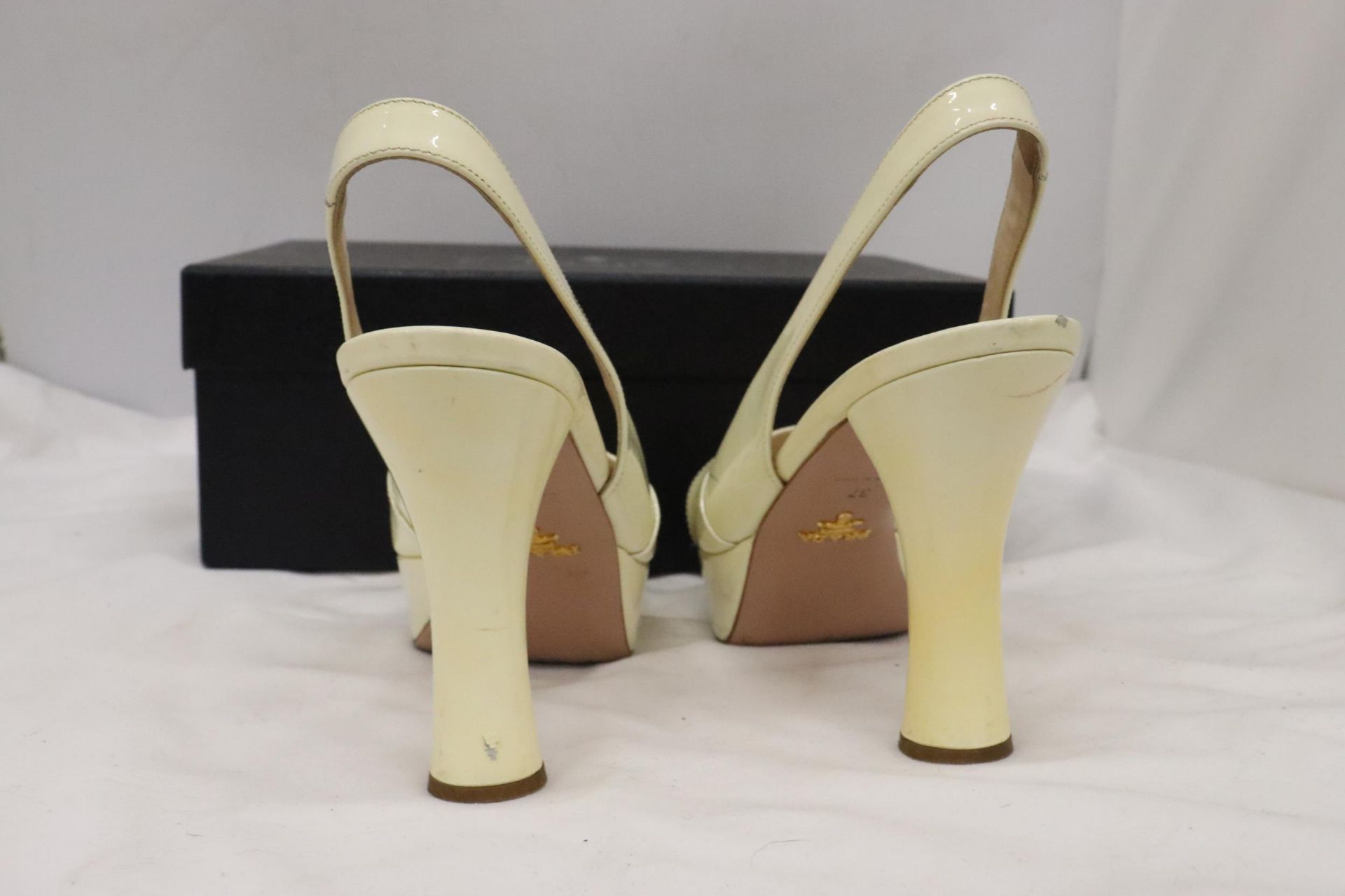 A PAIR OF CREAM HIGH HEELED SHOES, MARKED WITH A GOLD COLOURED 'PRADA' TO THE UNDERSIDE, IN A BOX - Image 4 of 7