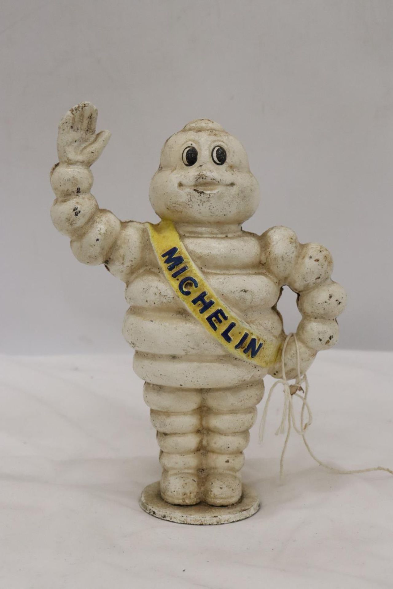 A CAST MICHELIN MAN FIGURE APPROX 21 CM TALL