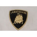 A TRIANGULAR BLACK AND GOLD CAST METAL LAMBORGHINI SIGN, 21CM X 18CM