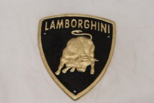 A TRIANGULAR BLACK AND GOLD CAST METAL LAMBORGHINI SIGN, 21CM X 18CM