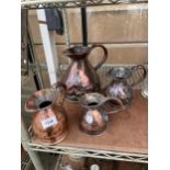 A COLLECTION OF FOUR GRADUATED VINTAGE COPPER MEASURING JUGS