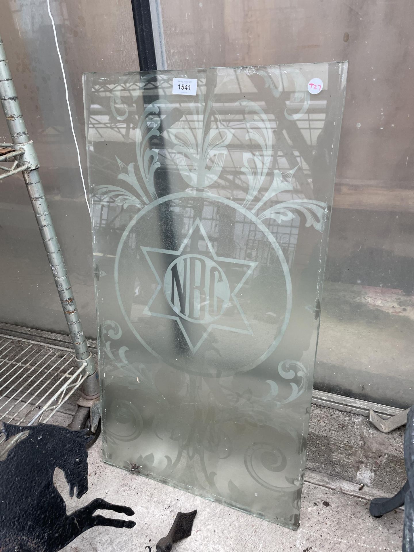 A PANE OF FROSTED GLASS ETCHED 'NBC'