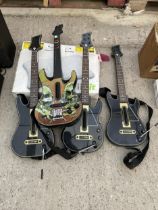 A WII FIT BOARD AND FOUR WII GUITARS