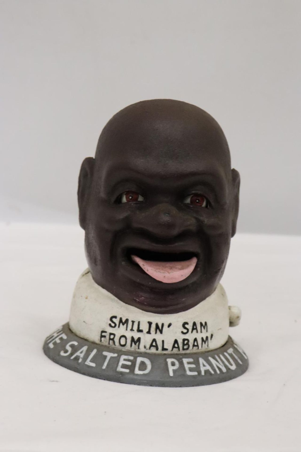 A HEAVY CAST IRON MONEY BOX, 'SMILIN' SAM, THE SALTED PEANUT MAN'