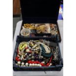 A LARGE QUANTITY OF COSTUME JEWELLERY TO INCLUDE AMBER STYLE BEADS, BANGLES, NECKLACES, BEADS,