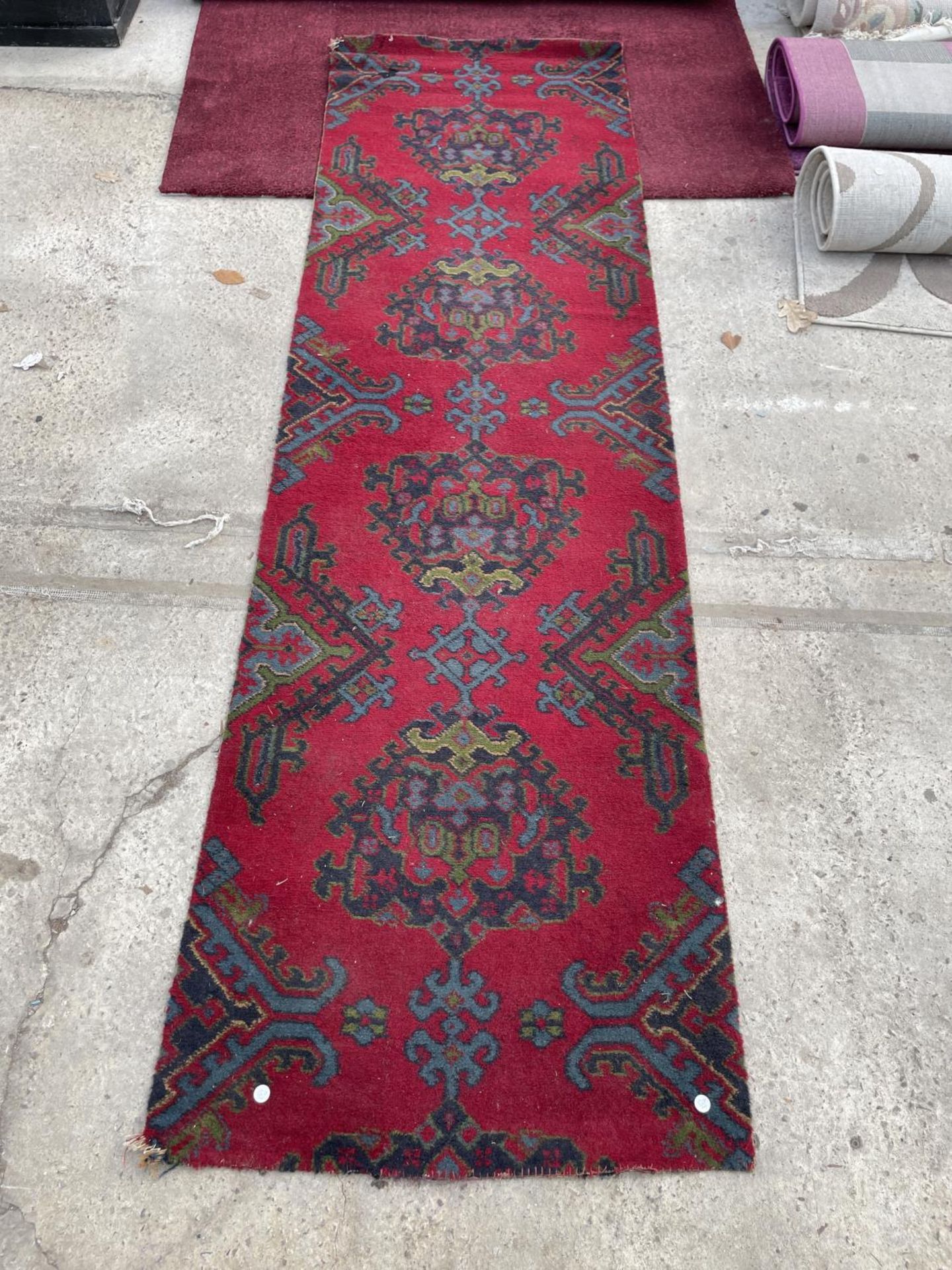 A SMALL RED PATTERNED RUG