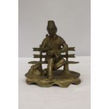 A BRASS SEATED MUSICIAN