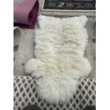 A SMALL SHEEP SKIN STYLE RUG