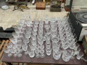 A LARGE QUANTITY OF CUT GLASS WARE TO INCLUDE SHERRY GLASSES, BRANDY BALLOONS AND WINE GLASSES ETC