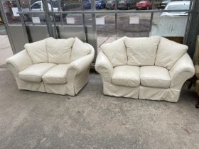 A PAIR OF WHITE LEATHER TWO-SEATER SETTEES