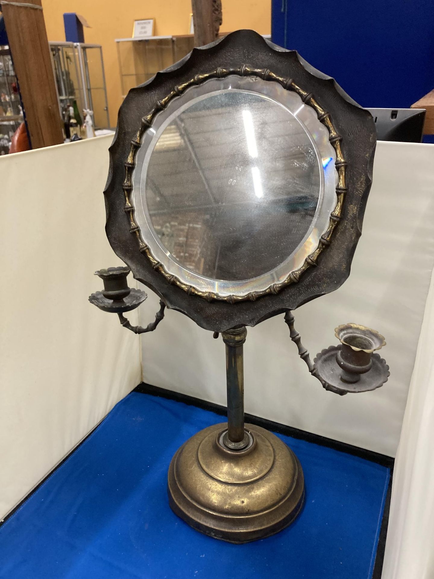 A VINTAGE ADJUSTABLE SHAVING MIRROR WITH CANDLE HOLDERS