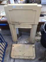 A RETRO CAST IRON FIRE SURROUND AND HARTH