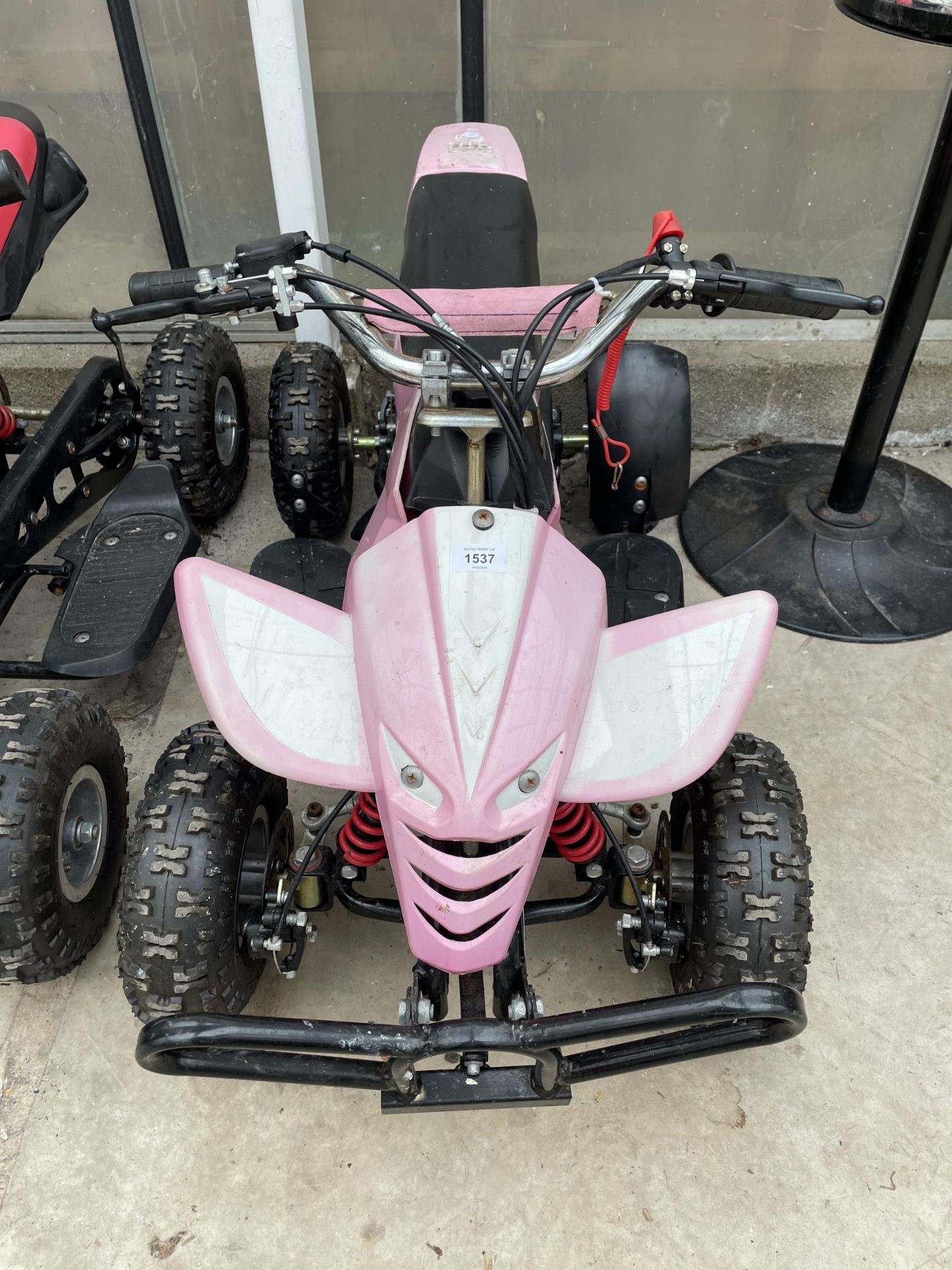 A PINK CHILDS PETROL GO KART COMPLETE WITH KEY