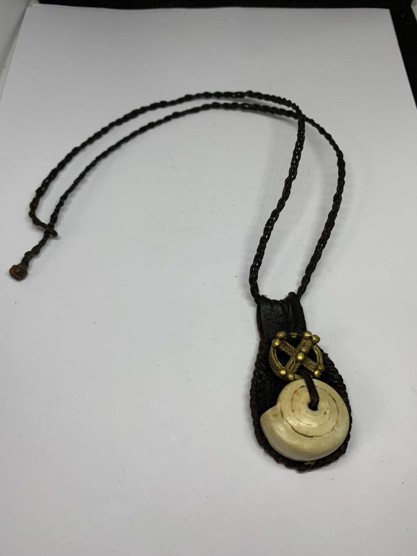 A TALISMAN GOOD LUCK AMULET ON LEATHER CORD