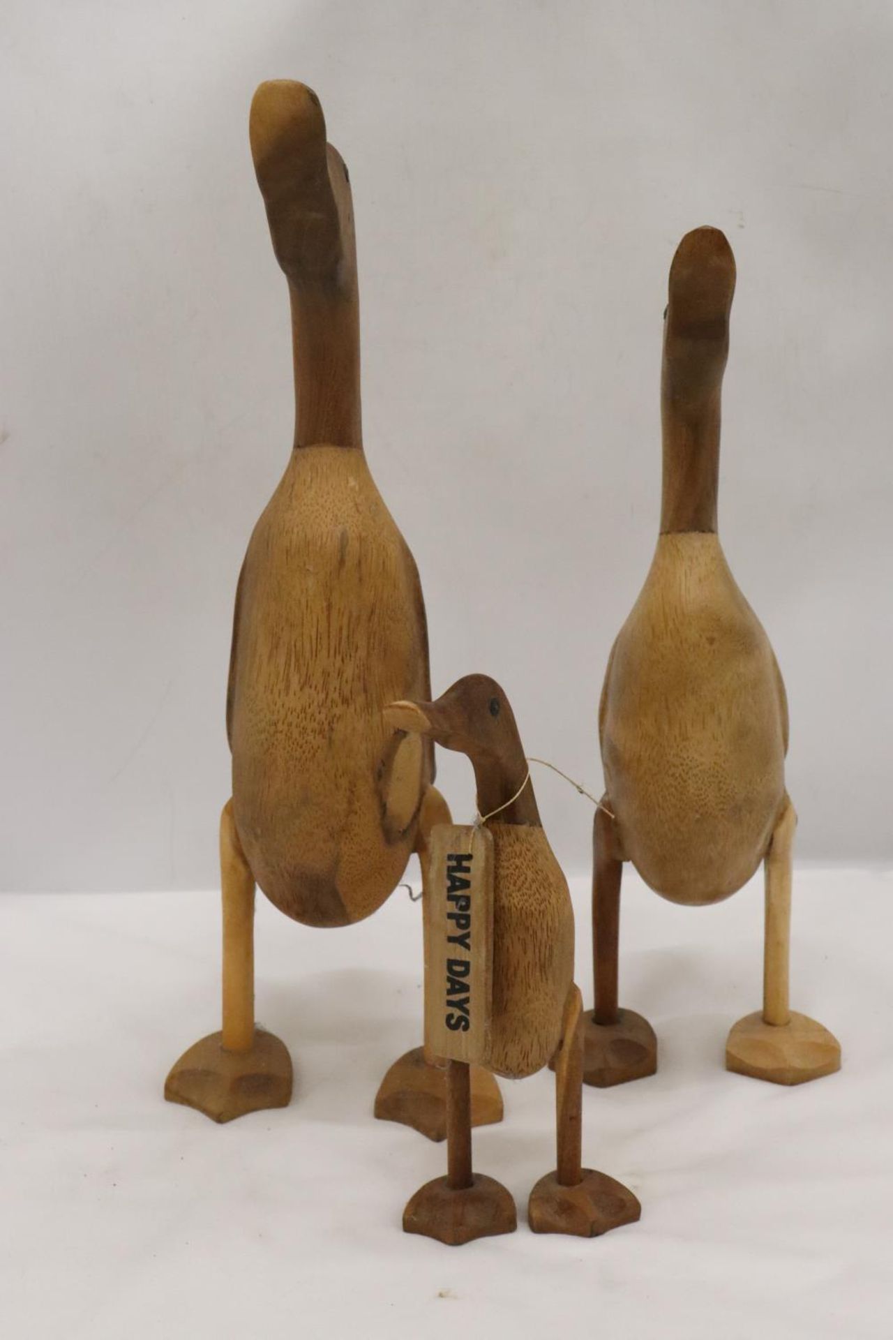 A WOODEN DUCK FAMILY TO INCLUDE DADDY DUCK, MUMMY DUCK AND BABY DUCK