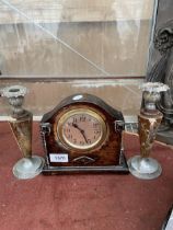 A VINTAGE OAK CASED MANTLE CLOCK AND A PAIR OF CANDLESTICKS