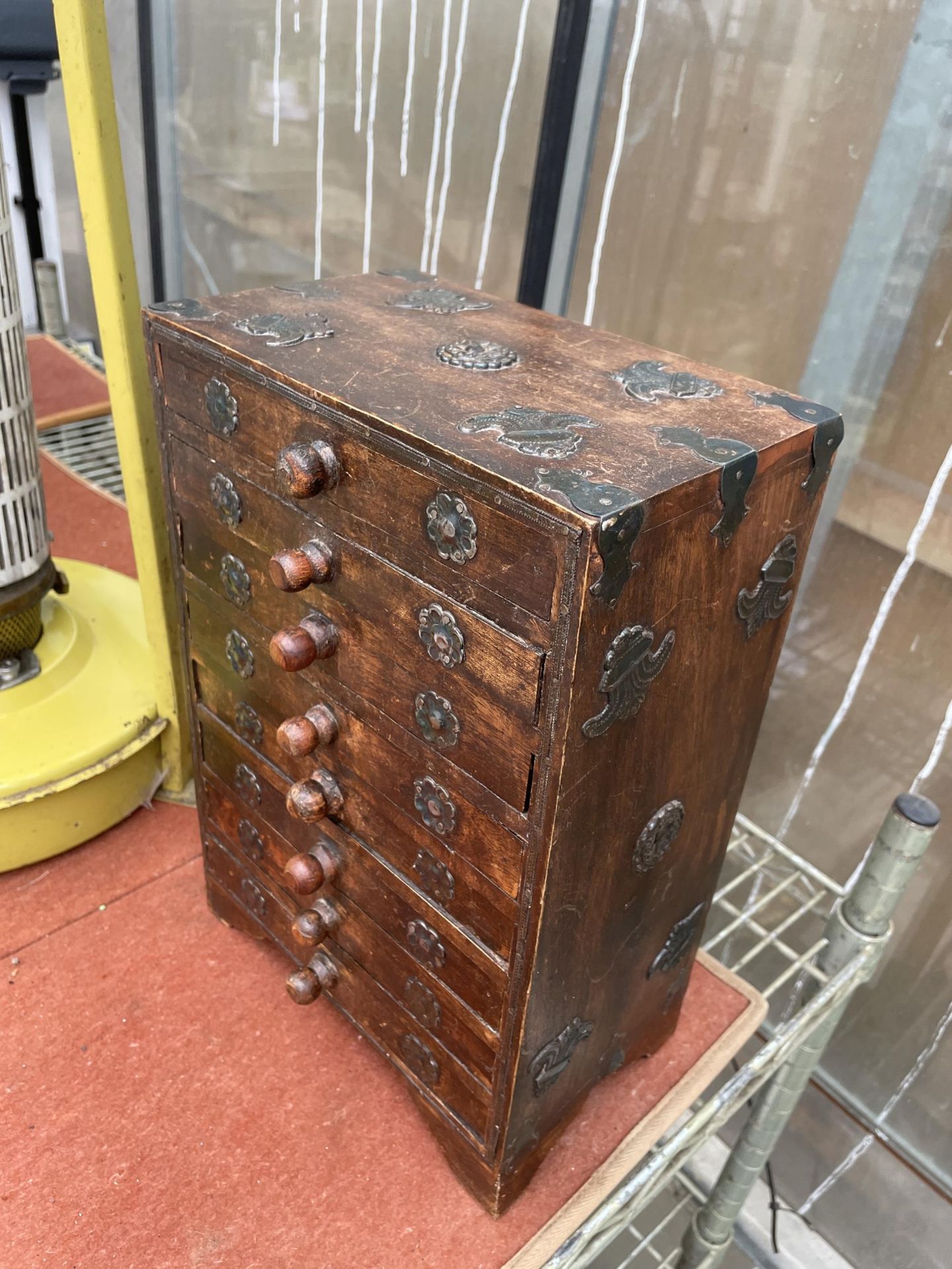 A MINIATURE INDIAN HARDWOOD CHEST OF EIGHT DRAWERS