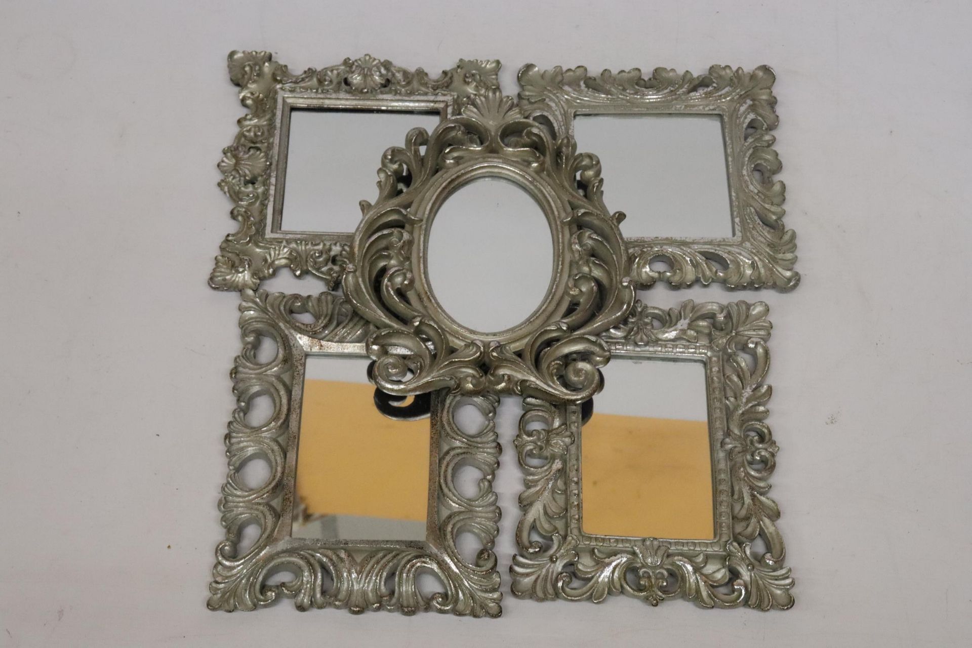 FIVE SMALL MIRRORS WITH ORNATE SILVER COLOURED FRAMES