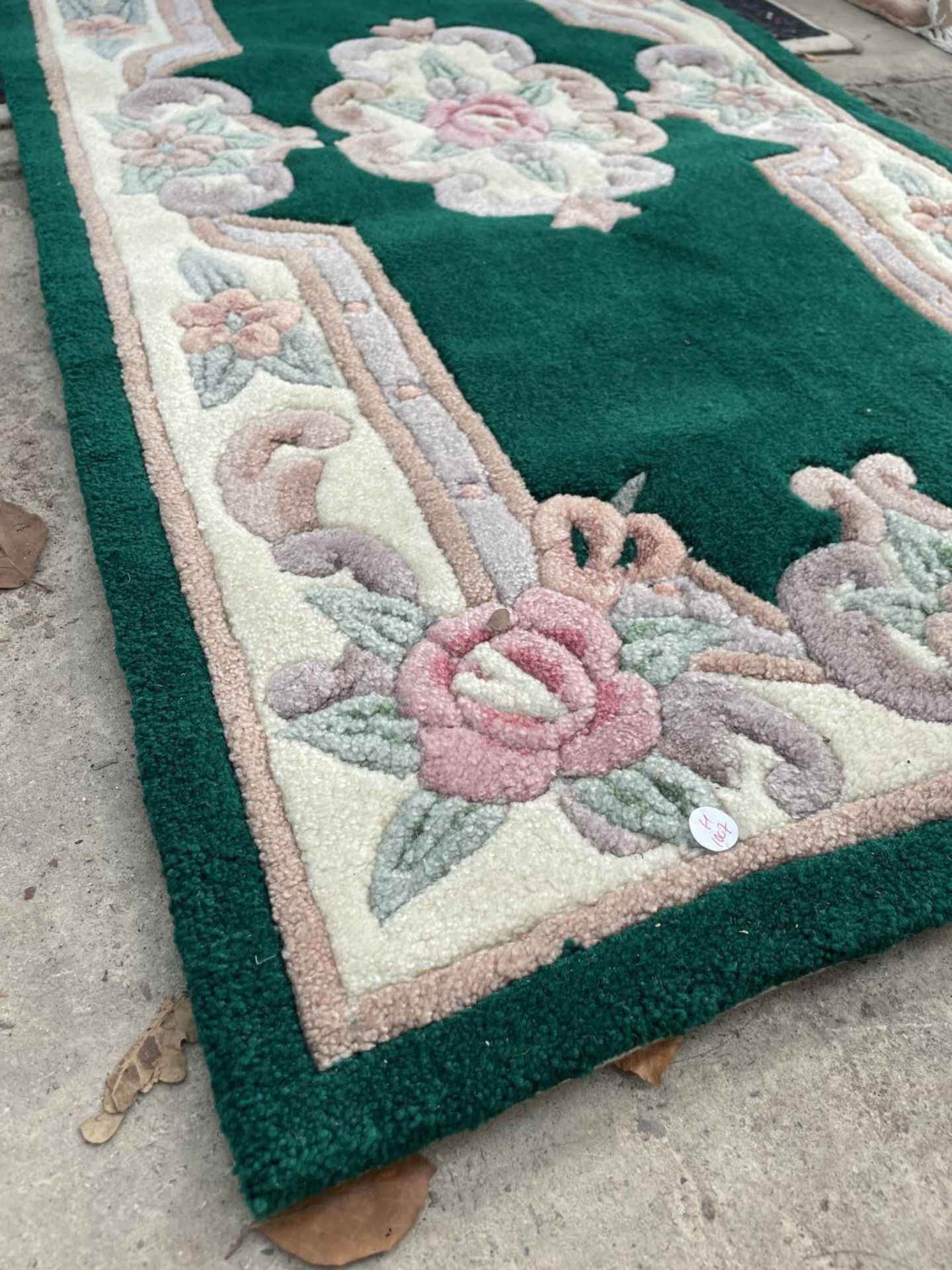 A SMALL GREEN PATTERNED RUG - Image 2 of 2