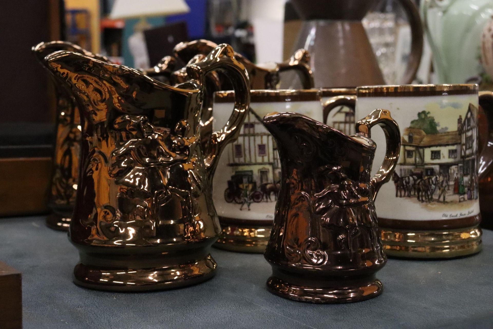 FIVE VINTAGE BRONZE LUSTRE WARE JUGS TOGETHER WITH THREE ARTHUR WOOD TANKARDS WITH COACHING SCENES - Image 4 of 7