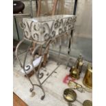 A DECORATIVE WROUGHT IRON PLANT STAND WITH PLANTER