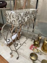 A DECORATIVE WROUGHT IRON PLANT STAND WITH PLANTER