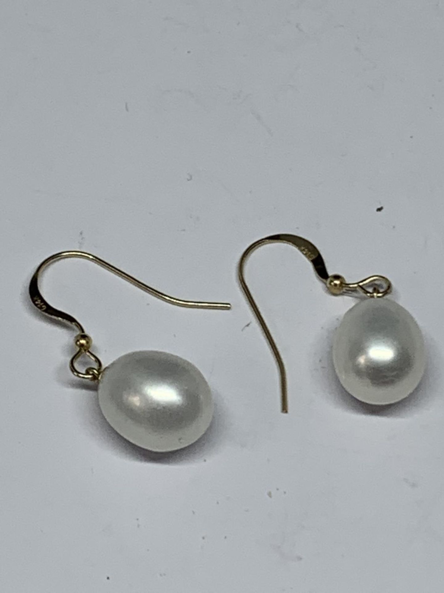 A PAIR OF 14 CARAT GOLD AND PEARL EARRINGS GROSS WEIGHT 3.57 GRAMS