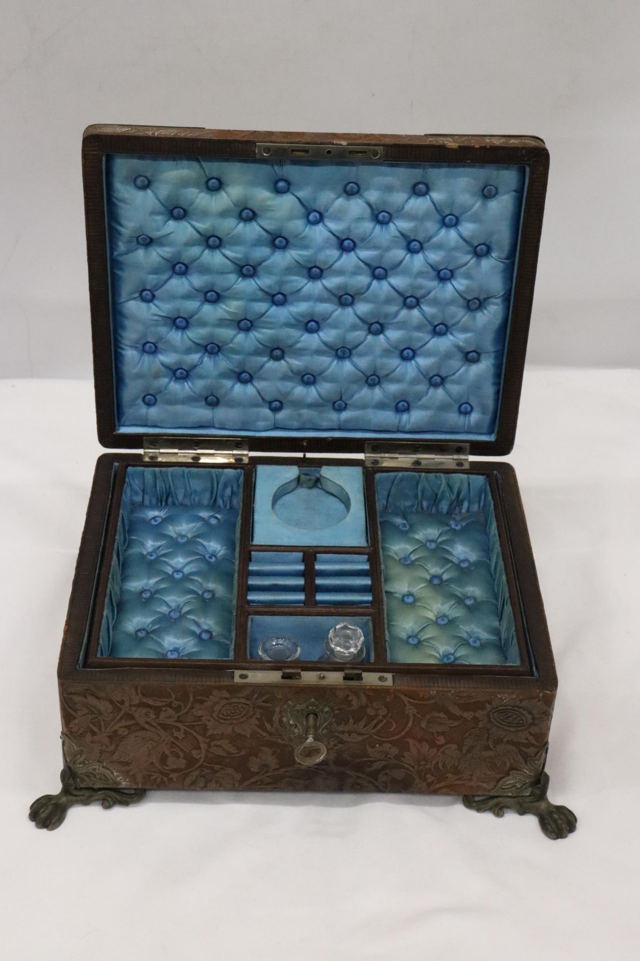 A SILK LINED, LEATHER CLAD JEWELLERY/SEWING BOX WITH TWO SCENT BOTTLES, A LIFT OUT COMPARTMENT AND